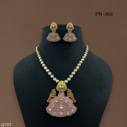 Beautiful combo of mossionite and Jadau kundan stones on baby pink carving stone